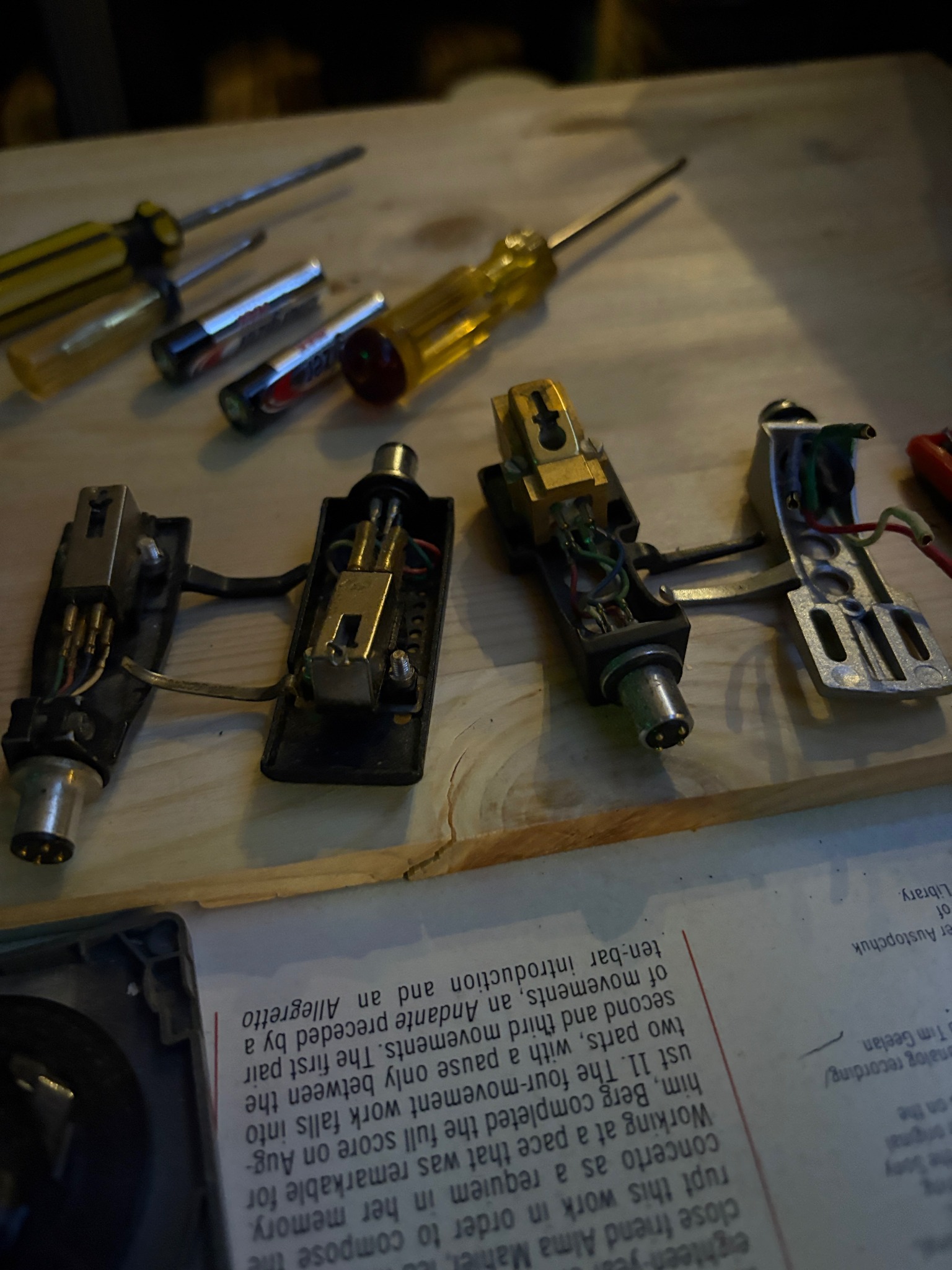 Audio cartridges and small screwdrivers arranged on a work surface